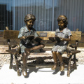 two children sitting on bench reading bronze statue sculpture